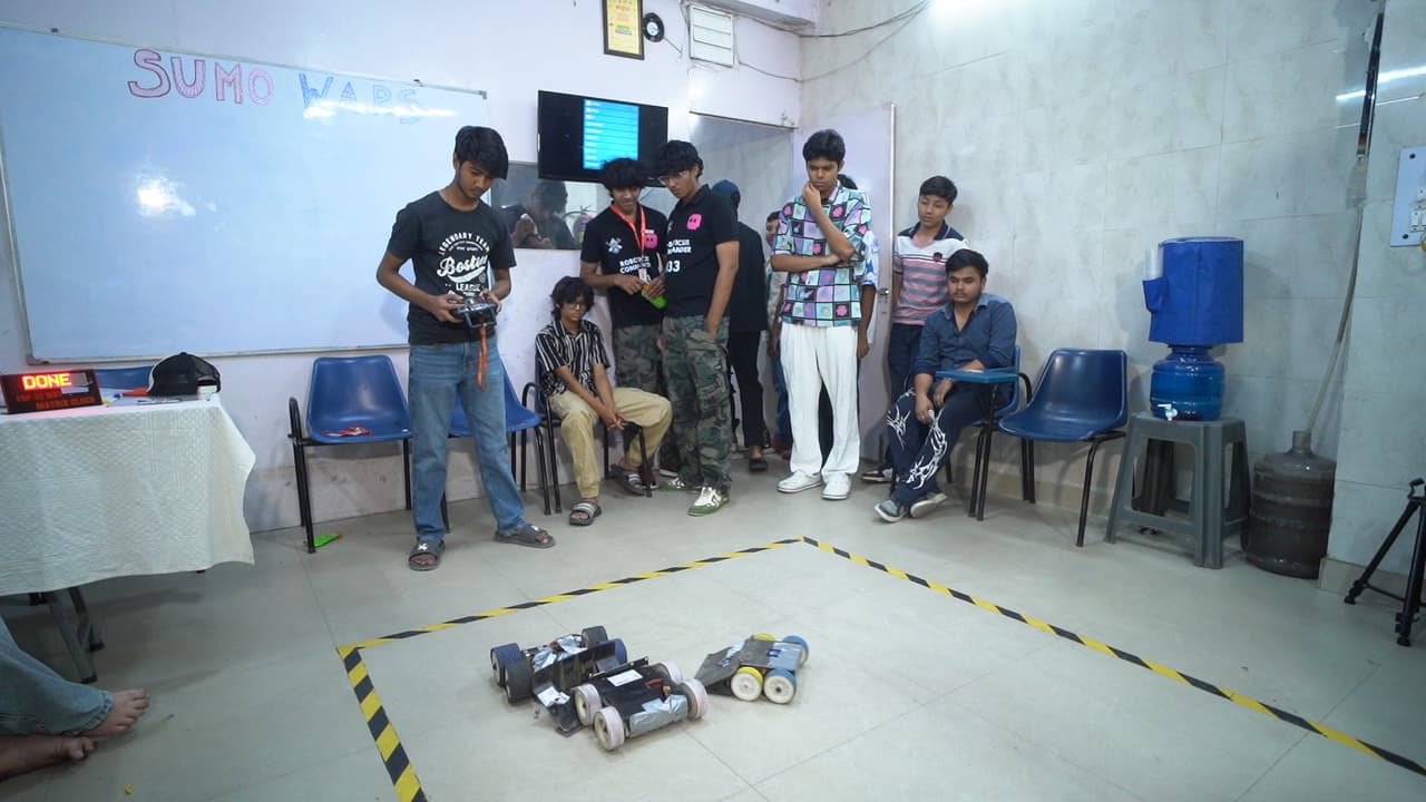 Autonomous sumo robots competing in the circular arena at Sumo Wars: First Edition 2026, organized by Robotic Sir AI India photo 3
