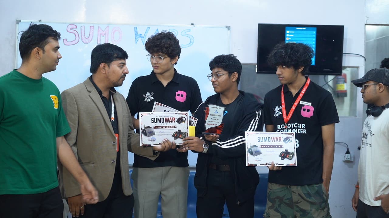 Autonomous sumo robots competing in the circular arena at Sumo Wars: First Edition 2026, organized by Robotic Sir AI India photo 5