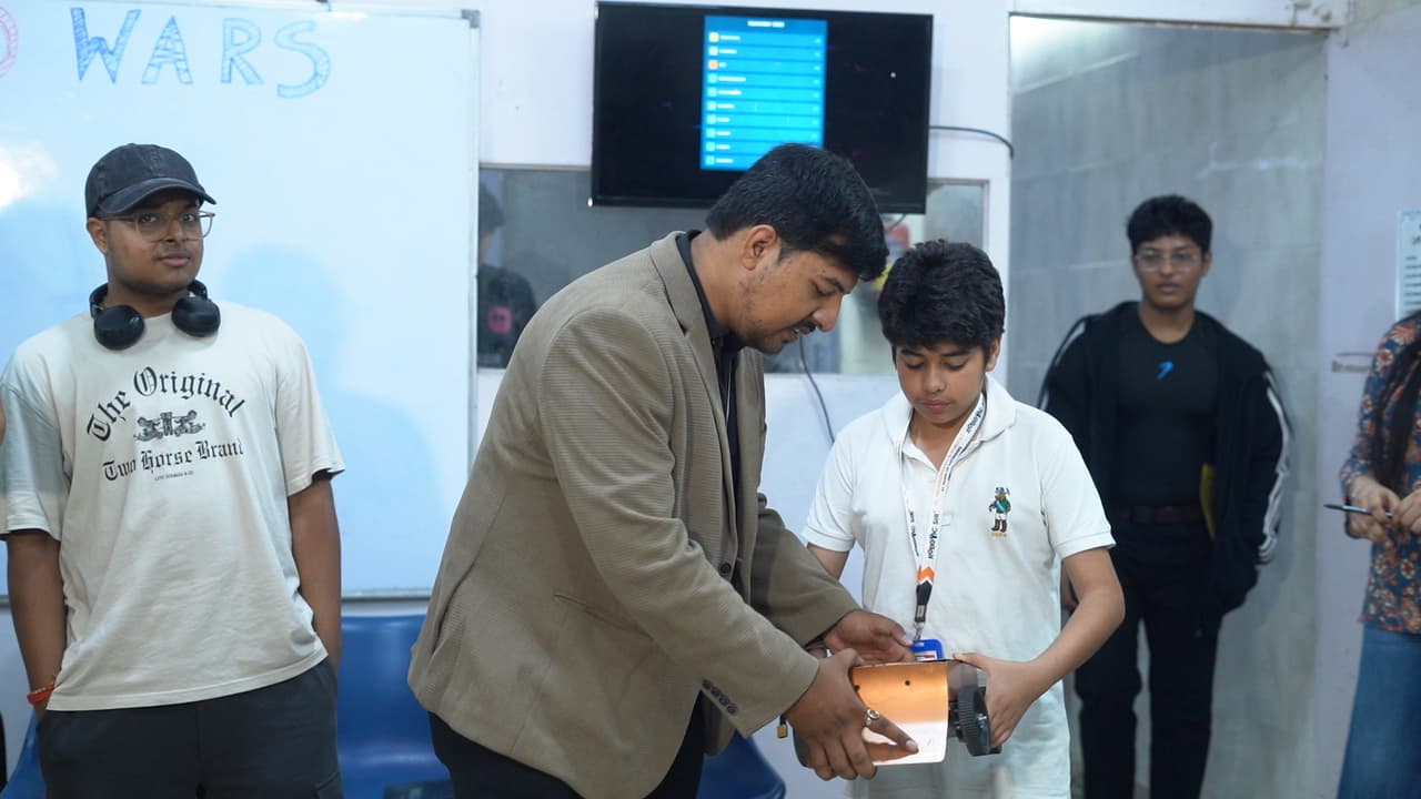 Autonomous sumo robots competing in the circular arena at Sumo Wars: First Edition 2026, organized by Robotic Sir AI India photo 6