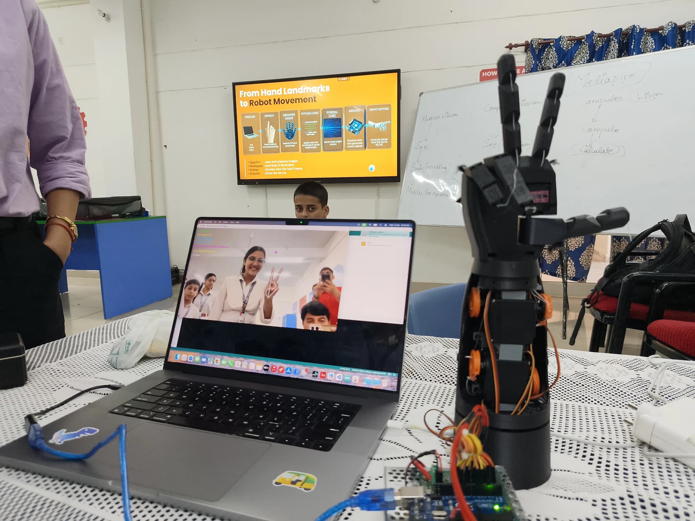 Army Public School Ratnuchak students exploring a gesture-controlled robotic hand during a practical AI and electronics workshop in Jammu. photo 1